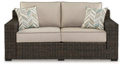 Coastline Bay Outdoor Loveseat with Cushion -  Ashley Furniture Outdoor Seating  Fresh Start Furniture